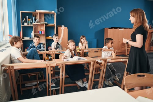 Preview: Enthusiastic Students Learning in Classroom with Teacher