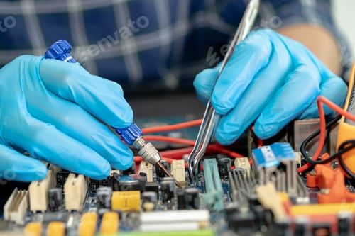 Preview: Technician repairing inside of mobile phone by soldering iron. Integrated Circuit.