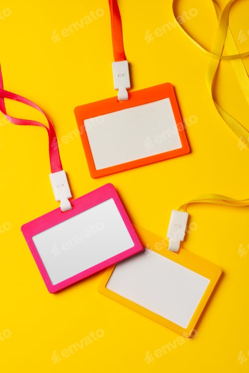 Preview: Colored blank nametags on strings on yellow background