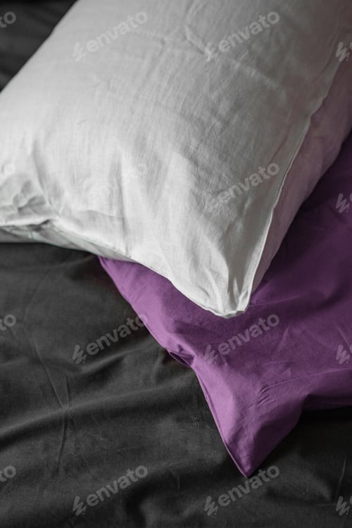 Preview: White and Purple Pillows on Gray Bed