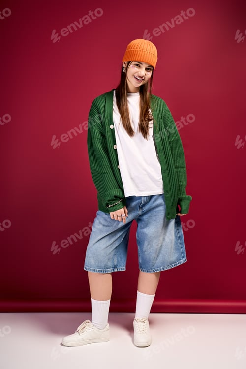 Preview: Stylish teenage girl wearing trendy winter outfits in vibrant studio setting