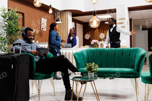Preview: Traveler listen to music at hotel lobby