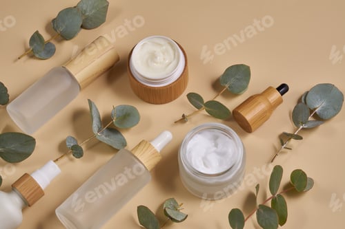 Preview: White frosted glass cosmetics bottles and jars with bamboo lids with tree bark, eucalyptus on beige