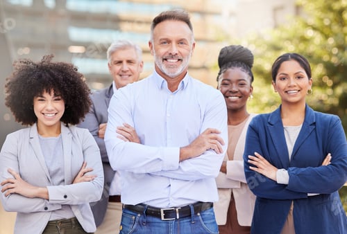 Preview: Shot of a diverse group of businesspeople standing outside on the balcony with their arms folded