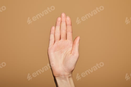 Preview: cropped view of man showing palm isolated on beige
