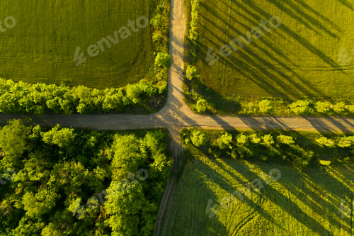 Vista previa: Beautiful aerial view of green fields and empty crossroad