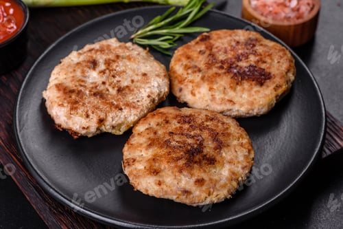 Preview: Flat lay composition with grilled meat cutlets for burger on black concrete table