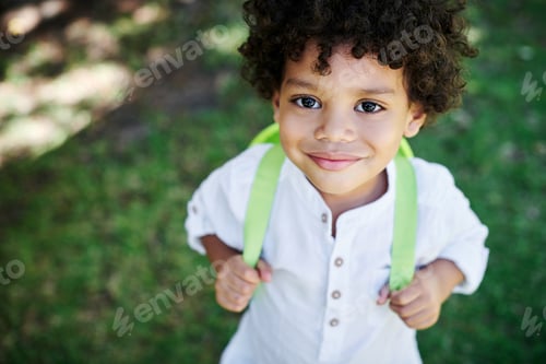 Preview: Im ready. Shot of a little boy wearing a backpack in nature.