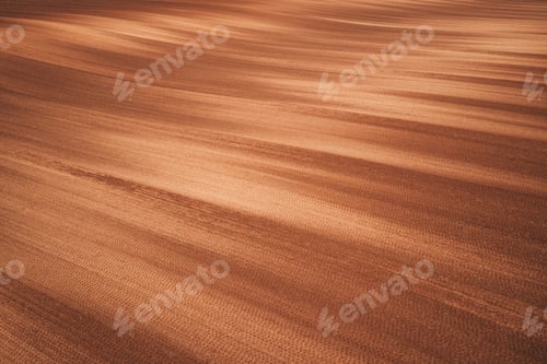 Preview: Plowed field on sunny spring day, aerial shot of brown soil with unique unusual pattern from above