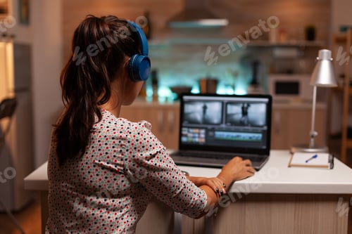 Preview: Woman working with video footage on laptop