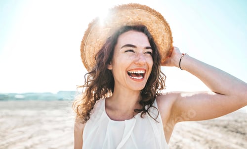 Preview: Happy beautiful young woman smiling at the beach side