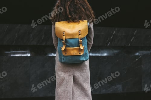 Preview: Young woman curly red head girl traveller with backpack and map in subway station
