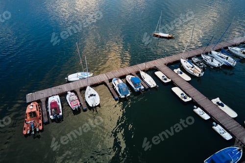 Preview: Aerial top view of boats near wooden pier at lake