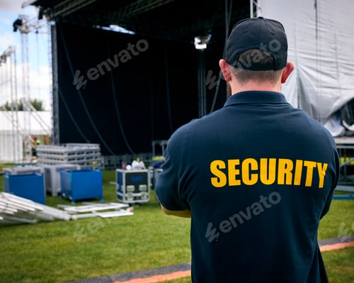 Preview: Rear View Of Security Team At Outdoor Stage For Music Festival Or Concert