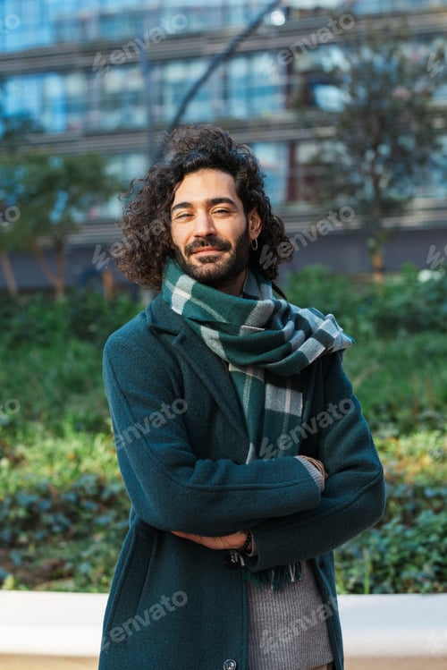 Preview: Businessman looking at camera while standing with his arms crossed on the street at financial