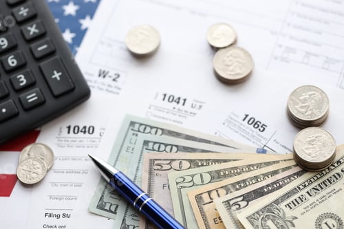 Preview: Tax Forms and Money on American Flag Background