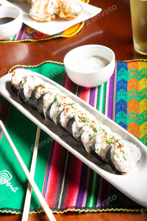 Preview: Japanese fish rolls with nori seaweed. Japanese food meal with chopsticks.