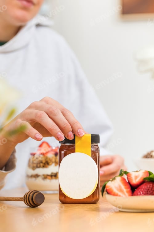 Preview: Honey jar with blank tag, strawberries and dipper on table