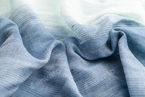 Preview: Fragment of blue linen tissue. Side view, natural textile background.