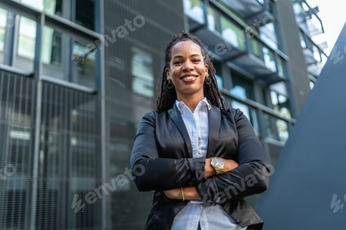 Preview: Latin confident woman standing in a financial district