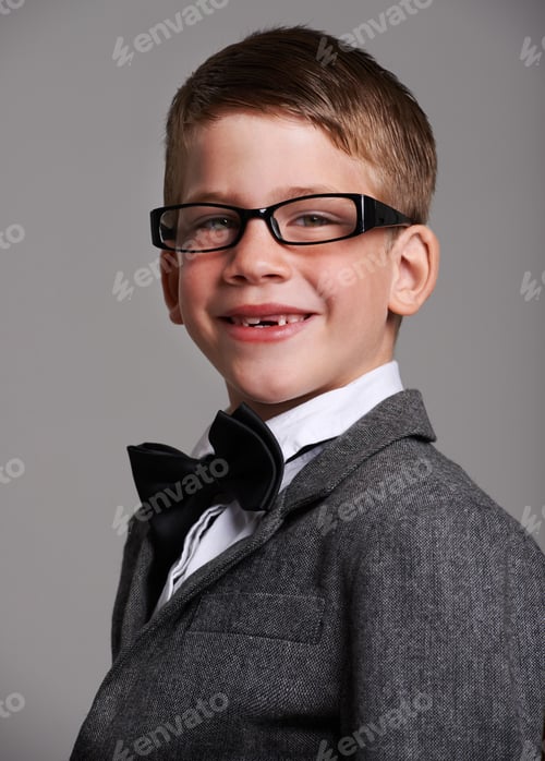 Preview: Hes a great dresse. Studio shot of a cute young boy wearing a retro suit against a grey background.