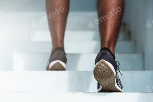 Preview: sport runner black man step running up to climbing stairs