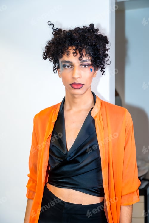 Preview: A man with a black shirt and orange jacket