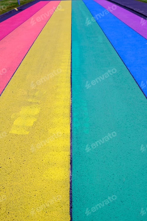 Preview: Vertical picture of street road painted in rainbow colors or lgtb flag.