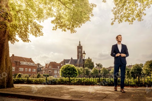 Preview: Netherlands, Venlo, businessman standing on pavement