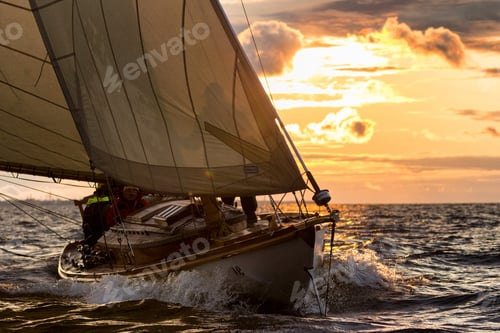 Preview: Breathtaking shot of a boat sailing in the wavy sea at sunset