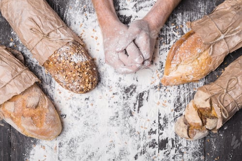 Preview: Bakery concept background. Hands and sorts of bread loaf