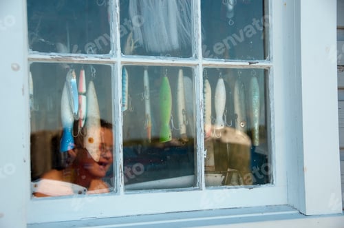 Preview: Reflection of smiling boy in window