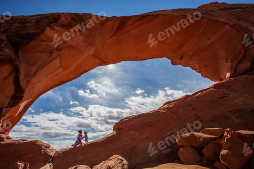 Preview: Mother With Her Baby Son Stay Below Skyline Arch In Arches National Park In Utah, Usa