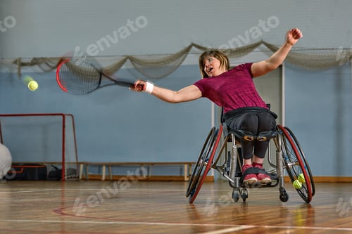 Preview: young woman on wheelchair playing tennis on tennis court
