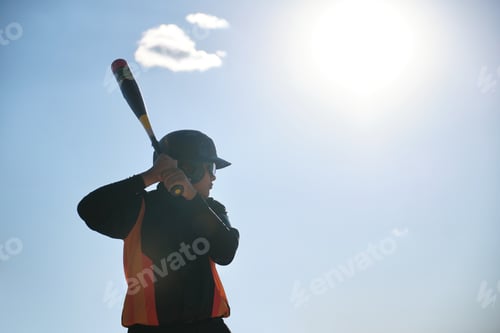 Preview: Young baseball batter preparing to swing during game
