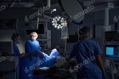 Preview: Group of surgeons in operating room with surgical laparoscopy equipment