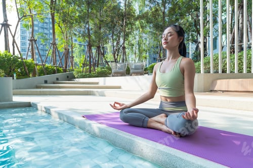Preview: Young female friends practicing yoga in various poses Trainer stretching muscles in morning