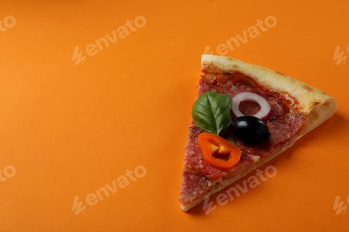 Preview: Slice of Salami pizza on orange background