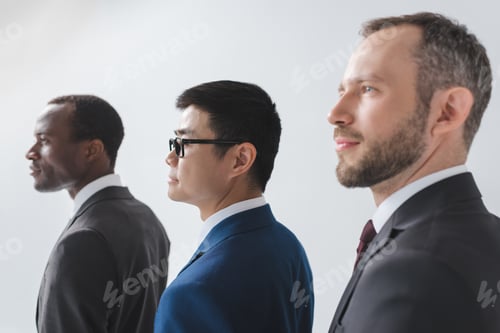 Preview: side view of multiethnic group of businessmen in suits isolated on grey