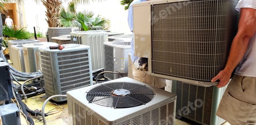 Preview: hvac technician removing old rusted broken airconditioners in HVAC at beach condo.