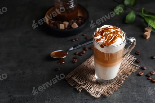 Preview: Glass cup with delicious caramel frappe on table