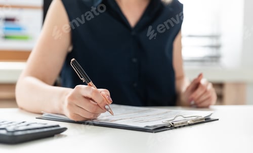 Preview: Woman Working in Office Filling out Form
