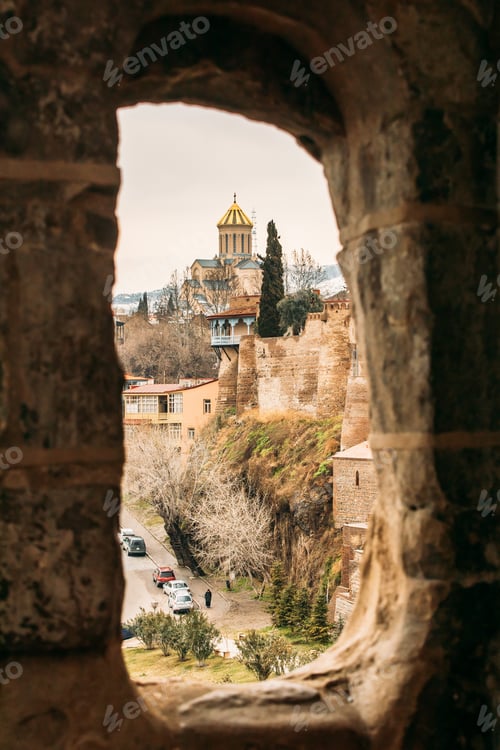 Preview: Tbilisi, Georgia. Scenic View Famous Landmark Sameba Church through ancient Metekhi church arch
