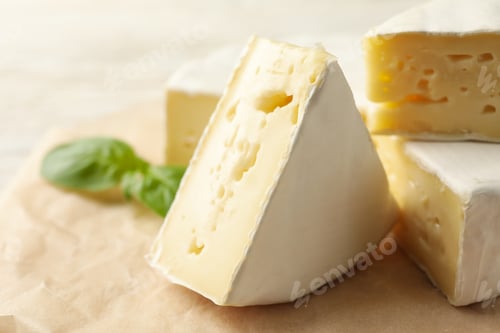 Preview: Baking paper with camembert cheese and basil, close up