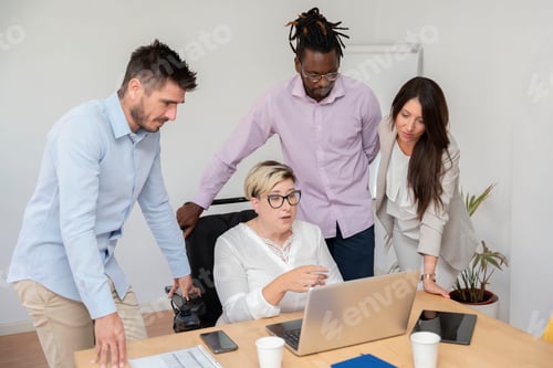 Preview: a businesswoman using a wheelchair in front of the laptop with her multiracial colleagues