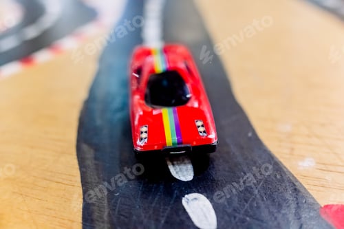 Preview: Generic toy cars in the foreground on a road.