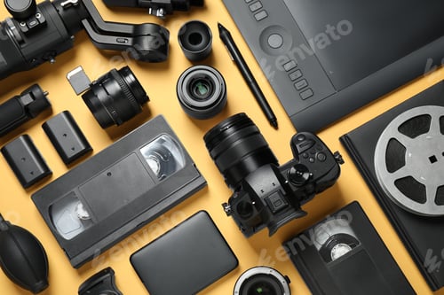 Preview: Flat lay composition with camera and video production equipment on yellow background