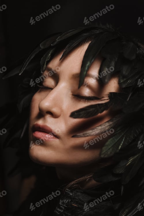 Preview: Portrait of a beautiful girl framed with black feathers