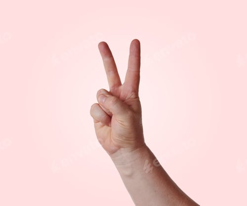 Preview: Hand showing victory sign on pink background