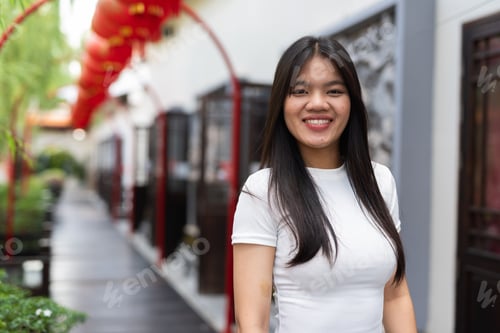 Preview: Portrait of beautiful Asian woman outdoors in Chinese style garden